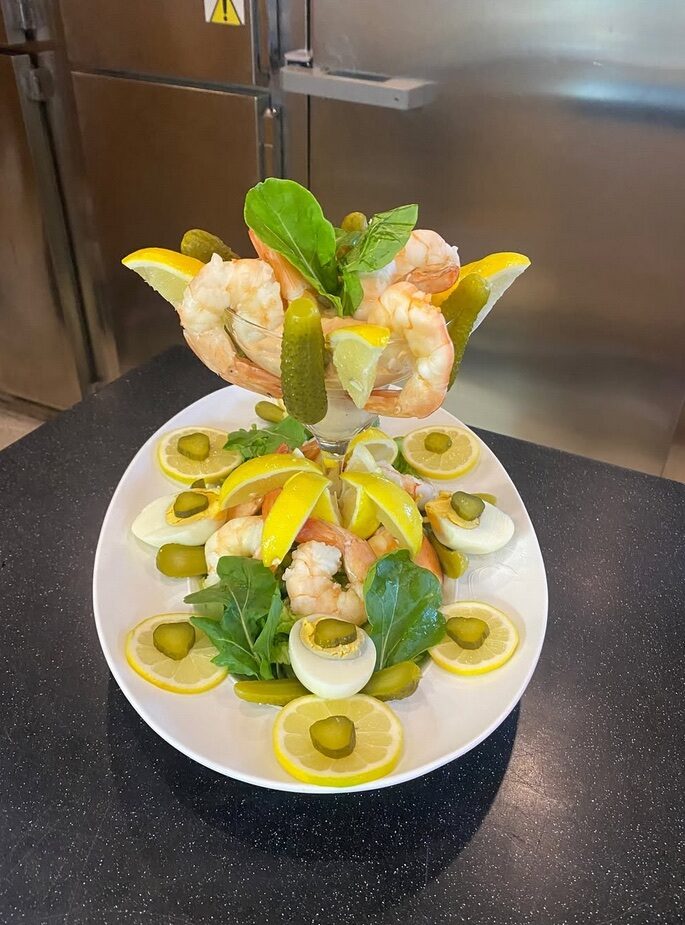 Small portions arranged on white plates at different levels.