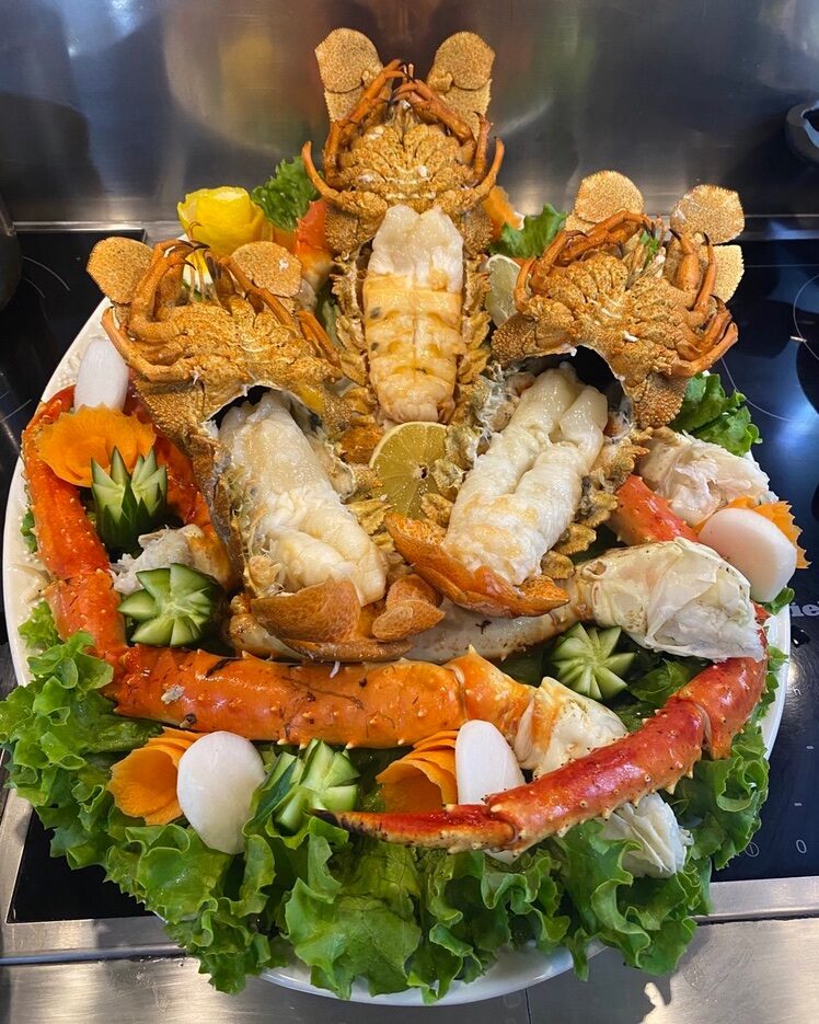 A multi-part arrangement on a large platter with a raised centre.