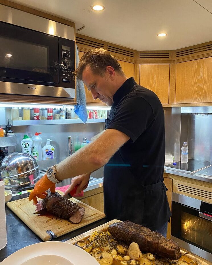 Hasan Emence working at a chopping board on a kitchen counter.